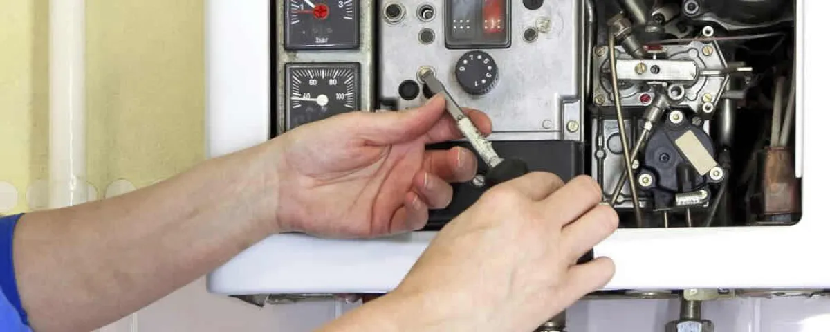 Heating repair technician adjusting boiler controls and components in Tucson, AZ