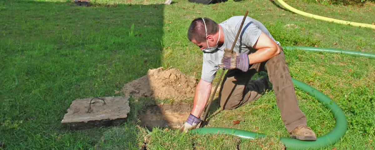 Septic pumping technician servicing a residential septic tank in Tucson, AZ